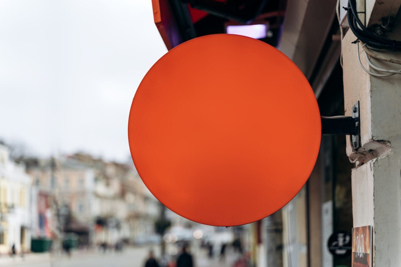 Mock-up of a round street signboard for outdoor advertising on the background of the house